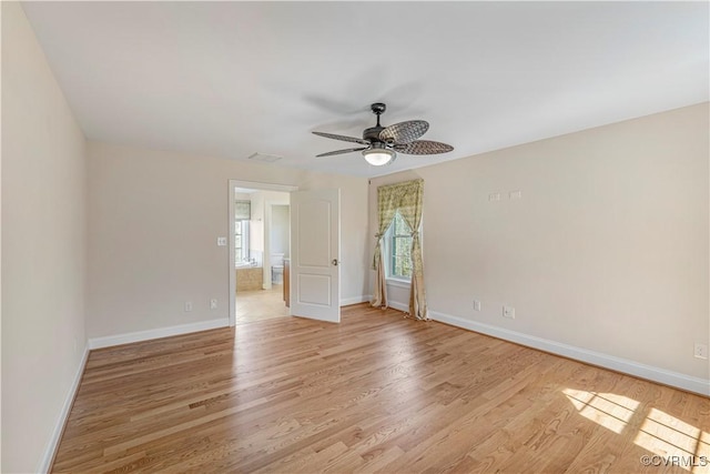 unfurnished bedroom featuring baseboards, light wood finished floors, and visible vents