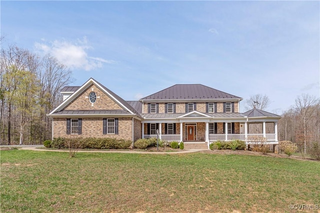 colonial inspired home with a porch, a standing seam roof, and a front lawn