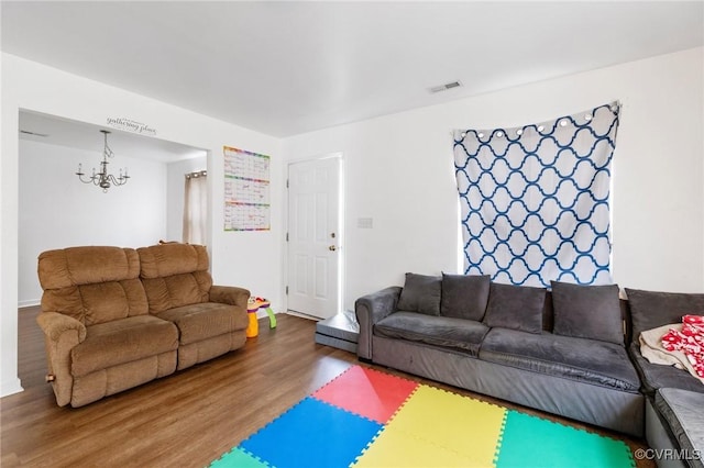2507 Wright Ave, Richmond, VA 23224 - living area featuring wood finished floors, a chandelier, and baseboards