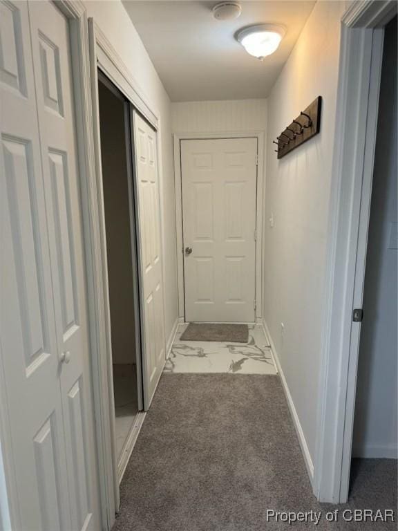 hall featuring baseboards and marble finish floor