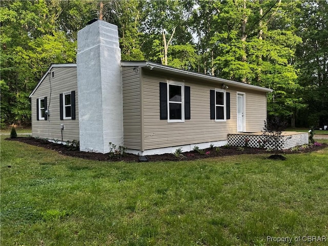 view of home's exterior featuring a yard and a chimney