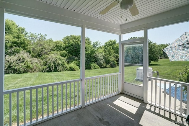 unfurnished sunroom with ceiling fan