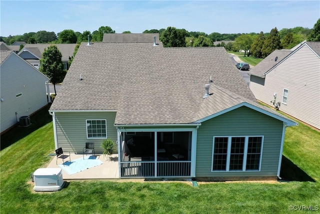 rear view of property with roof with shingles, a patio, a yard, and cooling unit