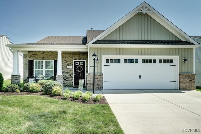 craftsman-style house with an attached garage, a shingled roof, board and batten siding, and driveway