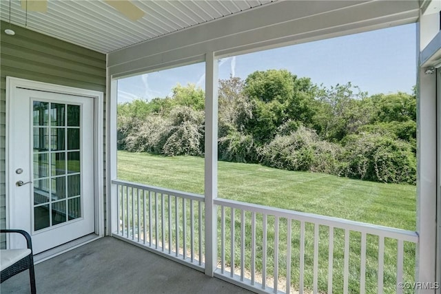 unfurnished sunroom with ceiling fan