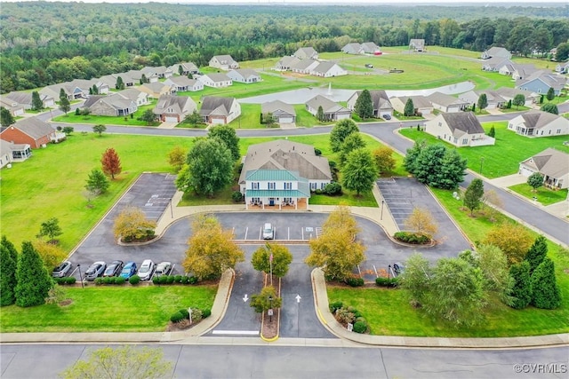 birds eye view of property featuring a residential view and a view of trees