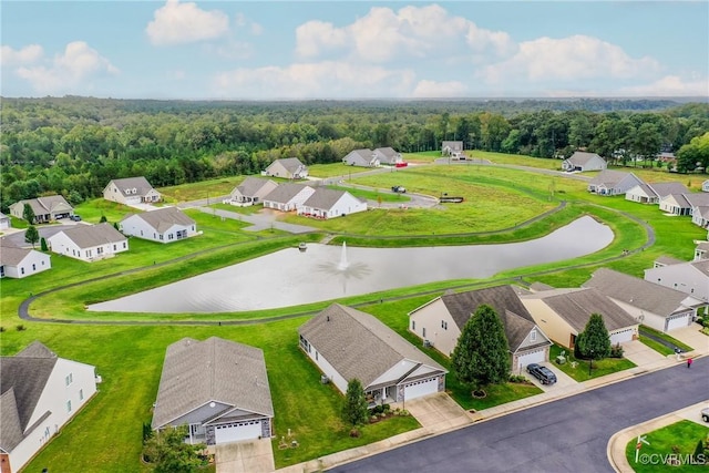 birds eye view of property featuring a water view, a residential view, and a wooded view