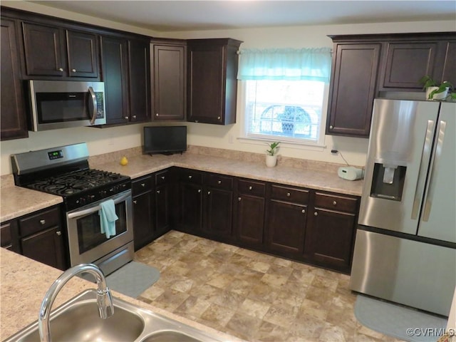 1632 Chestnut Park Ln, Richmond, VA 23222 - kitchen with light countertops, stainless steel appliances, dark brown cabinetry, and a sink