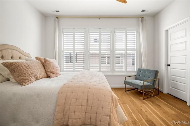 bedroom with visible vents and light wood-style flooring
