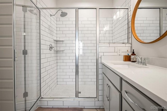 bathroom featuring a stall shower and vanity