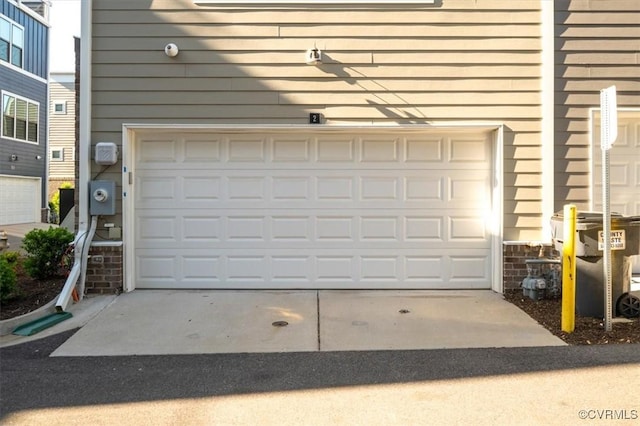 garage featuring concrete driveway