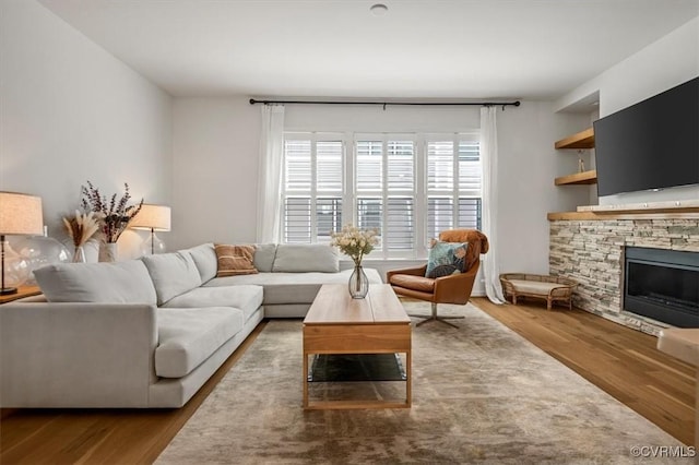 living room featuring wood finished floors and a fireplace