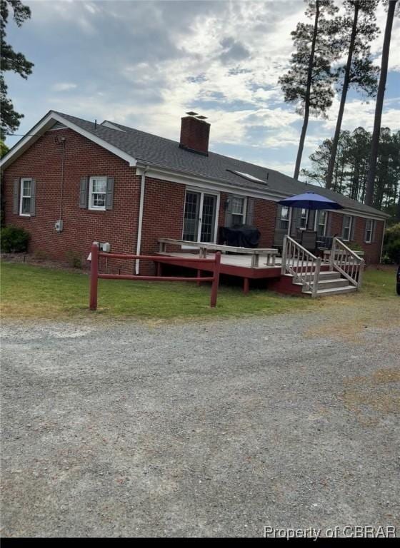79 Blue Crab Dr, Moon, VA 23109 - rear view of property with brick siding, a chimney, and a wooden deck