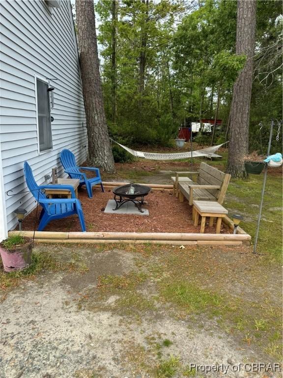 79 Blue Crab Dr, Moon, VA 23109 - view of yard featuring an outdoor fire pit