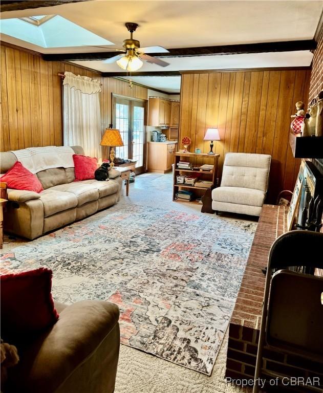 79 Blue Crab Dr, Moon, VA 23109 - living area featuring a skylight, wooden walls, carpet flooring, and ceiling fan