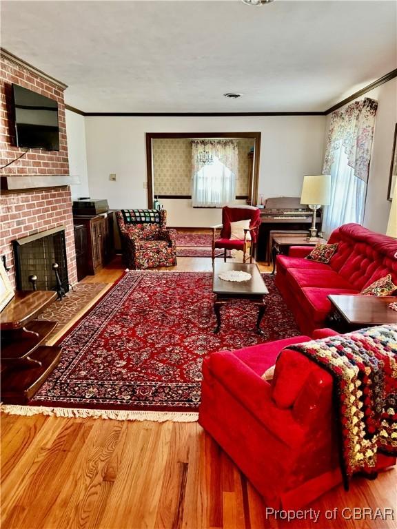 79 Blue Crab Dr, Moon, VA 23109 - living area with ornamental molding, a fireplace, and wood finished floors