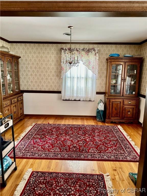 79 Blue Crab Dr, Moon, VA 23109 - dining space with light wood-type flooring, a chandelier, and wallpapered walls