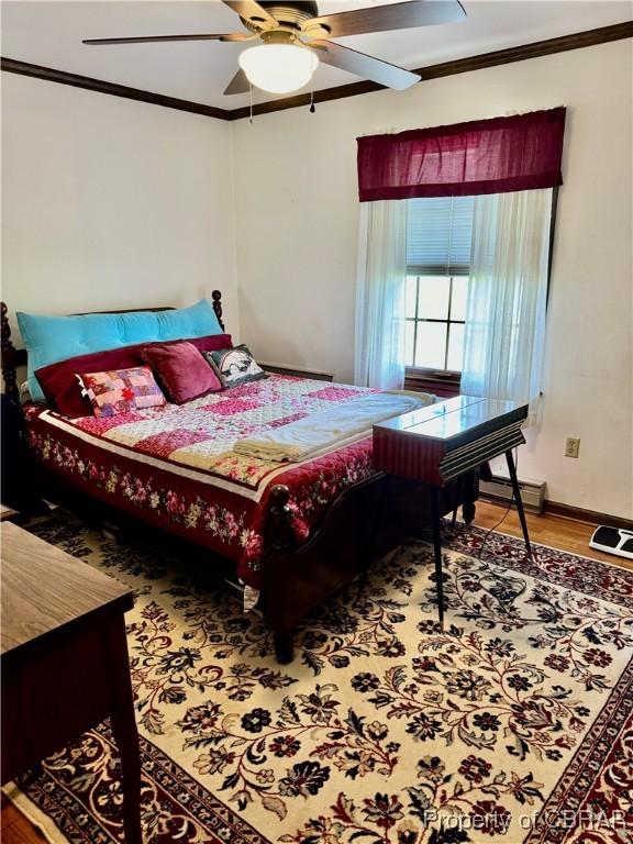 79 Blue Crab Dr, Moon, VA 23109 - bedroom with wood finished floors, a baseboard heating unit, a ceiling fan, and ornamental molding