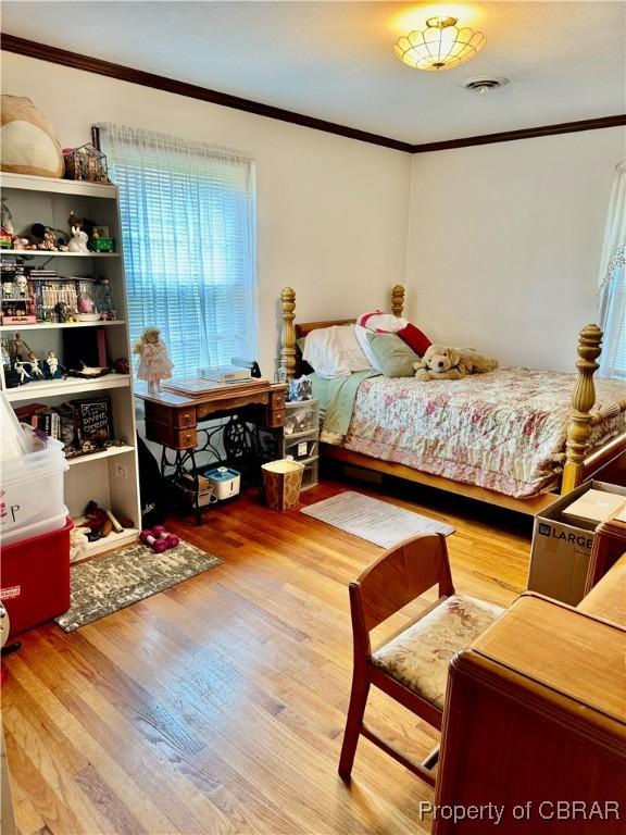 79 Blue Crab Dr, Moon, VA 23109 - bedroom with crown molding, visible vents, and wood finished floors