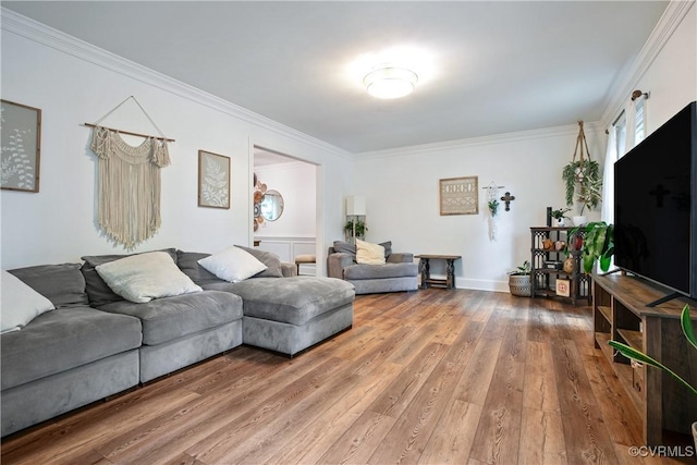 living area featuring crown molding and wood finished floors