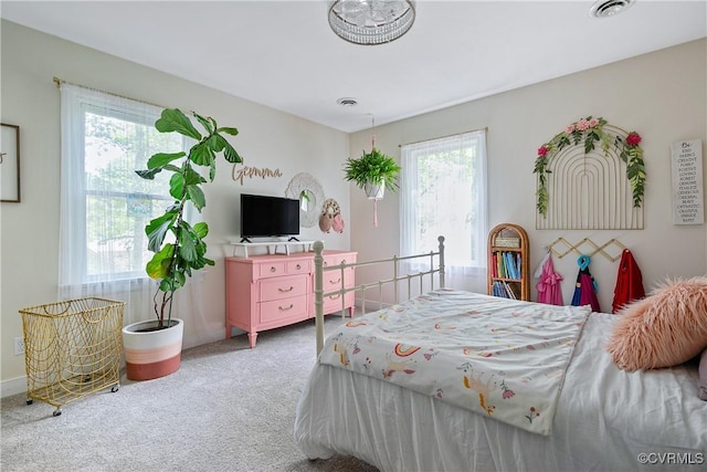 carpeted bedroom with baseboards and visible vents