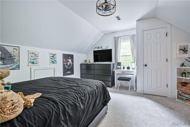 bedroom with vaulted ceiling, carpet flooring, and visible vents