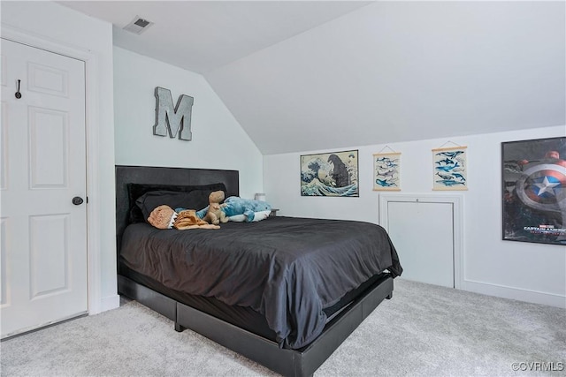 carpeted bedroom with lofted ceiling and visible vents