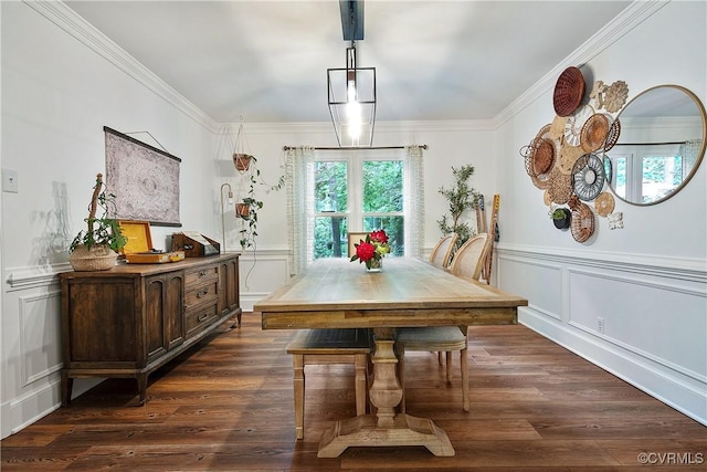 dining space featuring a decorative wall, crown molding, and dark wood-style floors