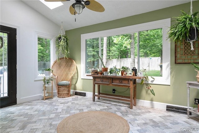 sitting room with visible vents, baseboards, lofted ceiling with skylight, and ceiling fan