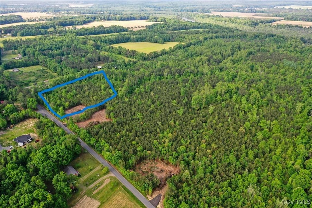 aerial view featuring a wooded view