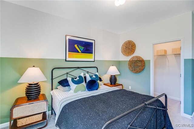 bedroom featuring a closet, baseboards, and carpet floors