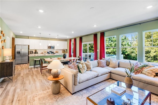 living area featuring light wood-style floors and recessed lighting