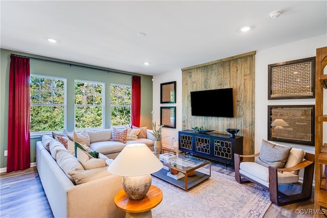 living room featuring recessed lighting, baseboards, and wood finished floors