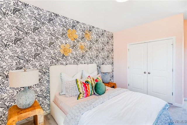 bedroom with carpet flooring, a closet, and baseboards
