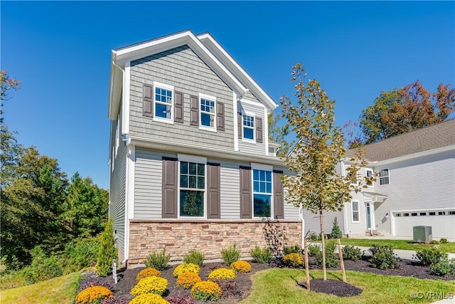 view of front facade with central AC and stone siding