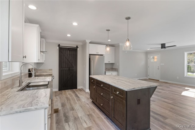 0 Union Church Rd, Palmyra, VA 22963 - kitchen with freestanding refrigerator, a barn door, a sink, dark brown cabinetry, and white cabinetry