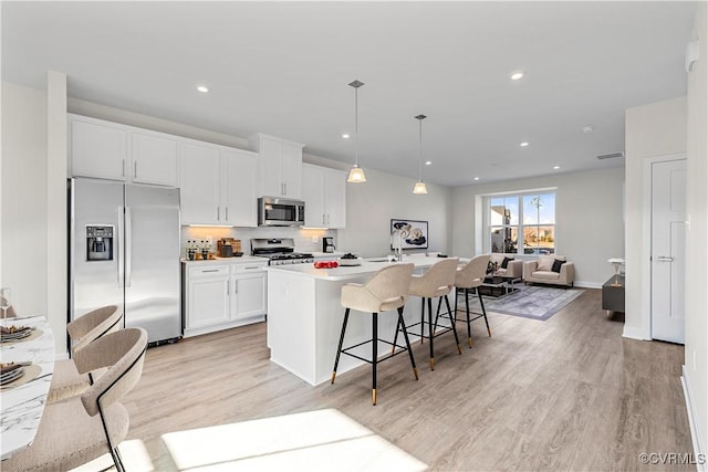 1255 Lazy River Rd, Chesterfield, VA 23114 - kitchen featuring appliances with stainless steel finishes, an island with sink, white cabinetry, open floor plan, and light wood-type flooring