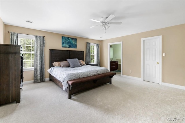 bedroom featuring light colored carpet, multiple windows, and baseboards