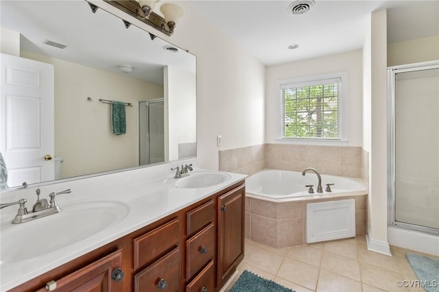 full bathroom with a stall shower, tile patterned flooring, a garden tub, and double vanity