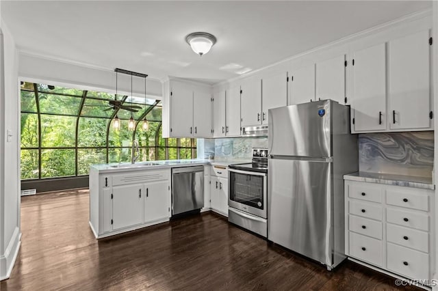 kitchen featuring appliances with stainless steel finishes, tasteful backsplash, dark wood finished floors, and white cabinetry