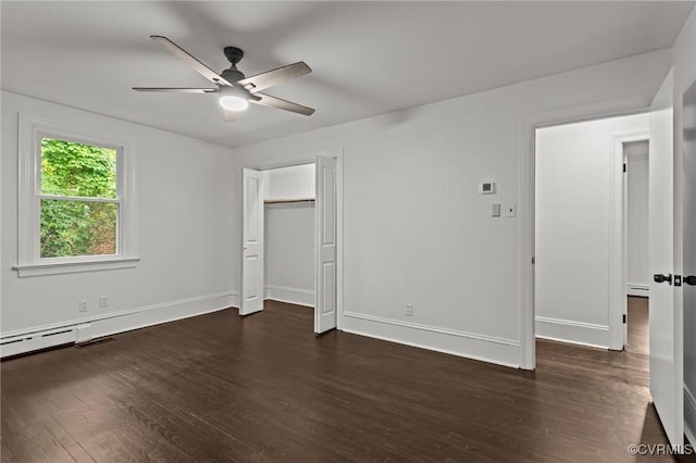 unfurnished bedroom with dark wood-style flooring, baseboards, a baseboard radiator, and ceiling fan