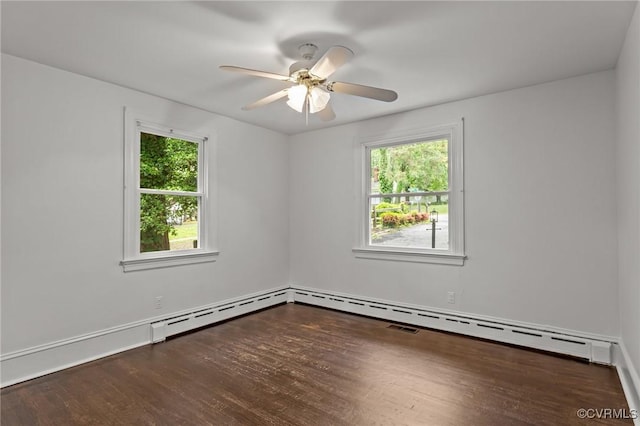 spare room with plenty of natural light, wood finished floors, ceiling fan, and baseboards
