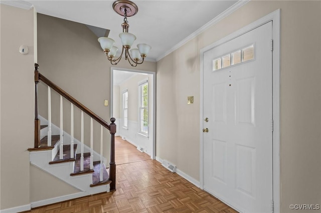 entrance foyer featuring a chandelier, ornamental molding, stairs, and baseboards
