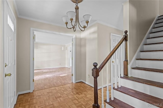 foyer entrance with stairs, a chandelier, ornamental molding, baseboards, and parquet flooring
