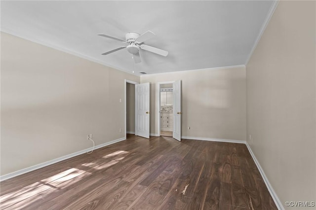 unfurnished room featuring crown molding, wood finished floors, baseboards, and a ceiling fan