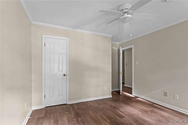 unfurnished bedroom with crown molding, dark wood-type flooring, baseboards, and ceiling fan