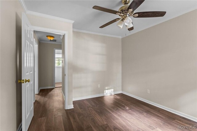 spare room featuring a ceiling fan, wood finished floors, baseboards, and crown molding