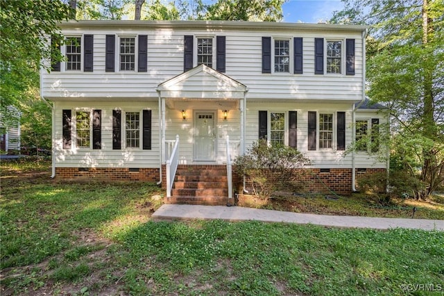 colonial house with crawl space and a front yard