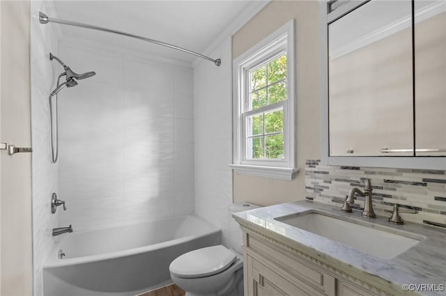 full bath featuring toilet, ornamental molding, vanity, decorative backsplash, and bathing tub / shower combination