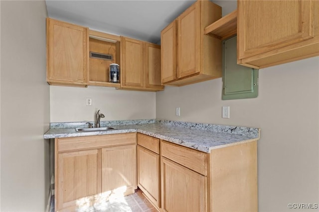 kitchen with open shelves, a sink, electric panel, and light brown cabinets